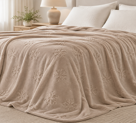 Snowflake cut‑flower flannel blanket, premium full‑size bedding laid on bed lifestyle scene