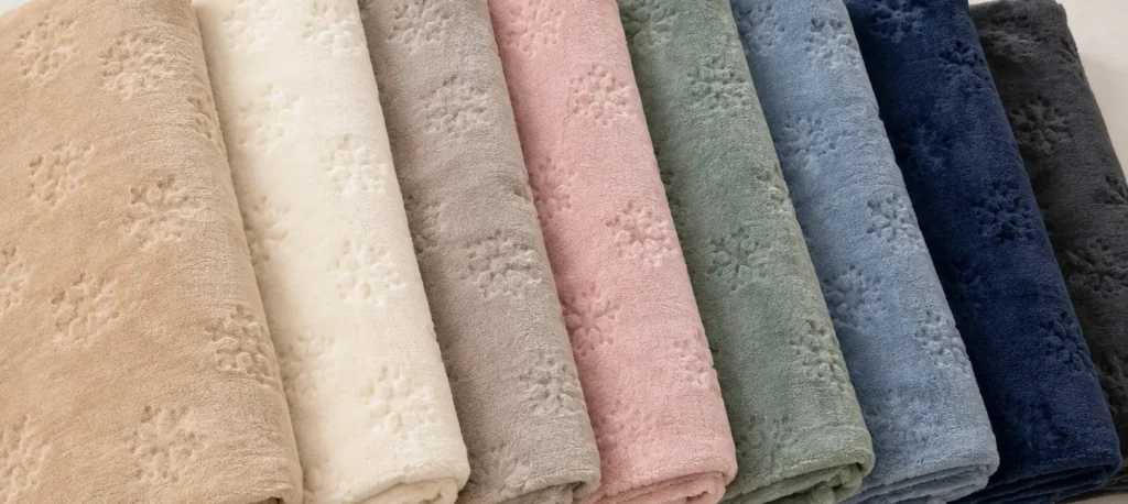 Stacked folded snowflake cut‑flower flannel blanket, 8 neutral pastel color options, soft plush home throw
