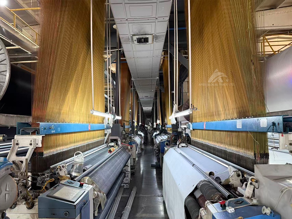 Jacquard weaving machines in textile workshop, producing curtain and blanket woven fabric