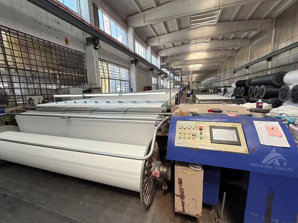 Textile factory workshop with large fabric rolls for home textile and blanket manufacturing