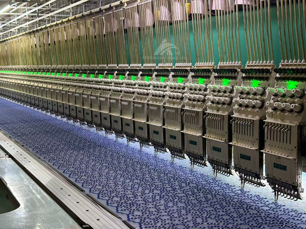 Textile factory workshop with knitting machines producing fabric for blankets and home textiles